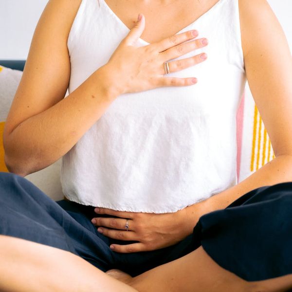 A person sitting calmly, embodying a state of well-being and mental clarity.